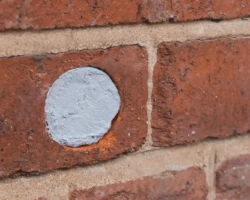 Hole in a brick wall patched with Flexi Armour